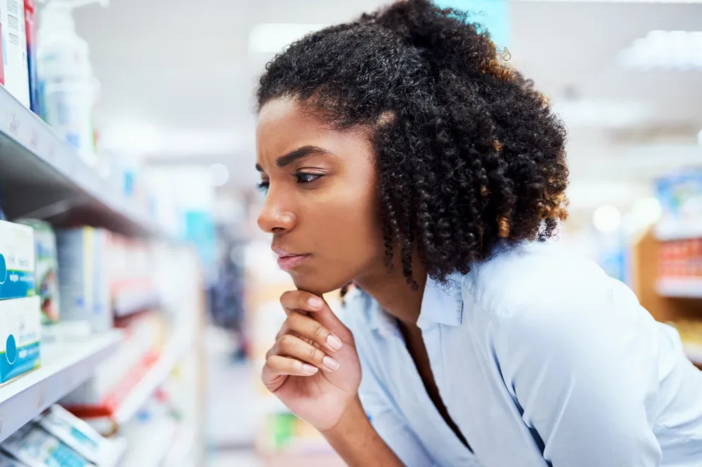 Young woman looking at products in a pharmacy